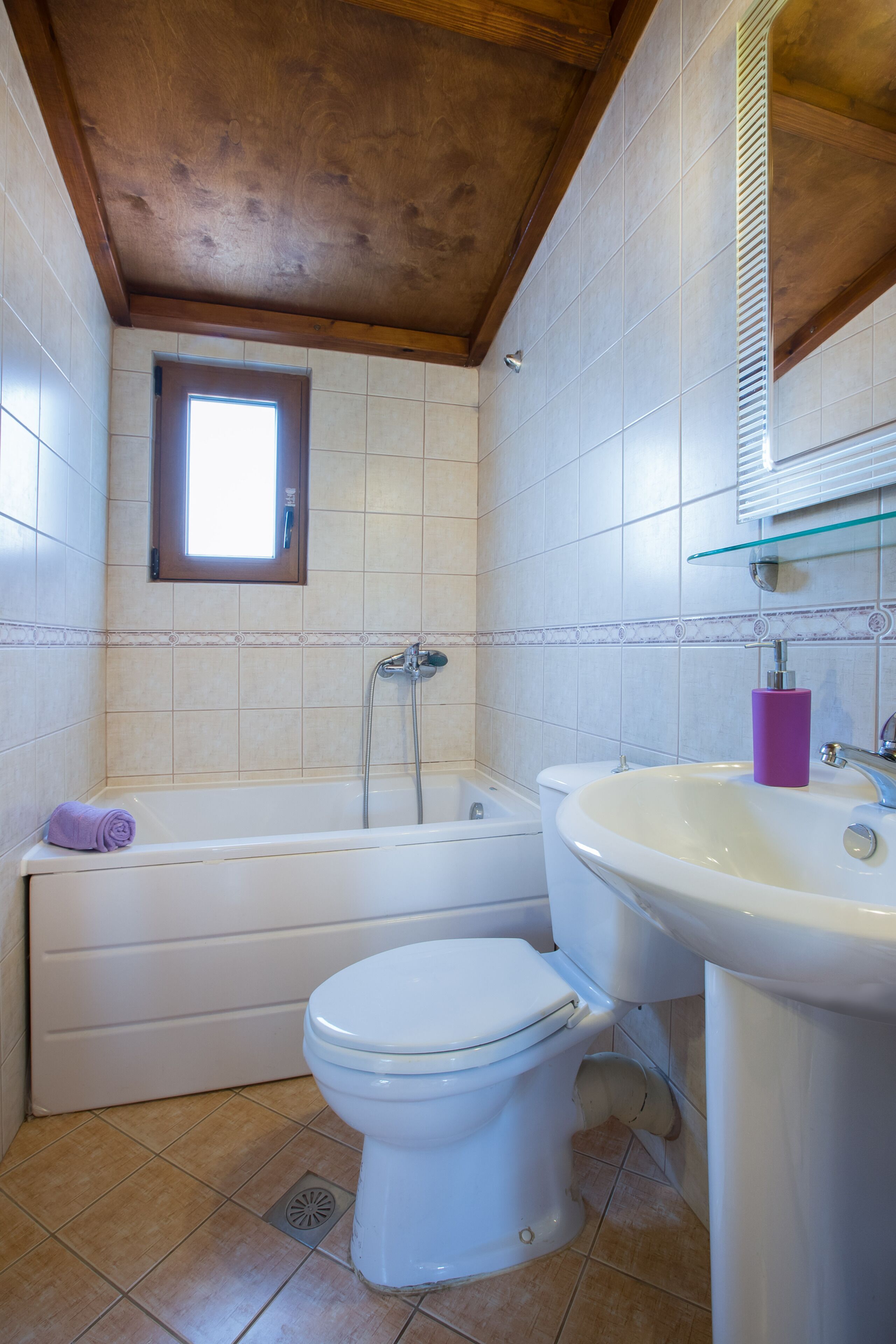 A bathroom with a bathtub, toilet, and sink.