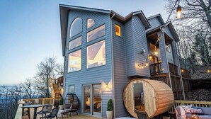 A modern two-story house with a hot tub, deck, and outdoor seating area. - Designer Home w/ Incredible Views, Sleeps 16 (Wintergreen Resort)