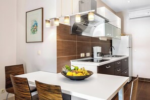 Enjoy cooking in this well-equipped kitchen with a stainless steel range hood, oven, sink, and dishwasher.