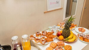 A breakfast buffet with pastries, fruits, and beverages. - Romatic Guest House  (Rome)