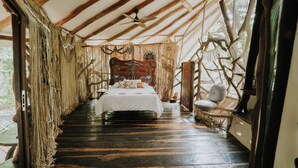 A room with a bed, a chair, and a ceiling fan. - El Sueño Riviera Maya (Tulum)