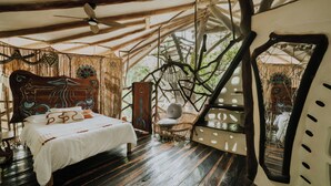 A room with a bed, a chair, a wooden ceiling, and a large window. - El Sueño Riviera Maya (Tulum)