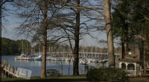 Steps from the water with a private dock, a big relaxing porch & great amenities