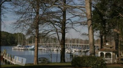Steps from the water with a private dock, a big relaxing porch & great amenities
