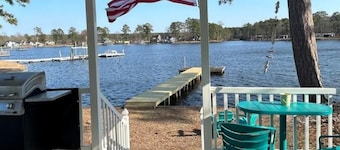 Steps from the water with a private dock, a big relaxing porch & great amenities