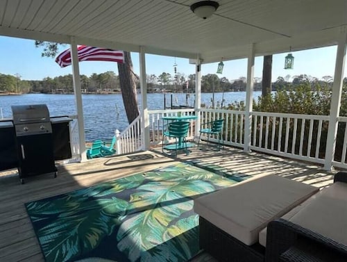 Steps from the water with a private dock, a big relaxing porch & great amenities