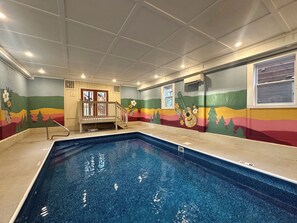 An indoor swimming pool with a colorful mural, a wooden deck, and a ceiling with recessed lighting. - Dolly's Lodge - 8 Bedroom w/ PRIVATE HEATED INDOOR POOL (Pigeon Forge)