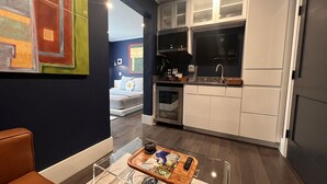 A modern kitchen with white cabinets, a built-in oven, and a microwave. - Stay At Jimmy's (Woodstock)