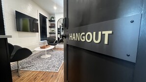 A modern interior with a black wall-mounted sign reading "HANGOUT". - Stay At Jimmy's (Woodstock)