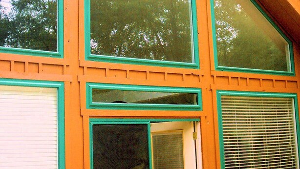 A building with large windows and a sloped roof. - Forest Get Away! Surrounded by National Forest. Beautiful home in the woods.  (Mena)