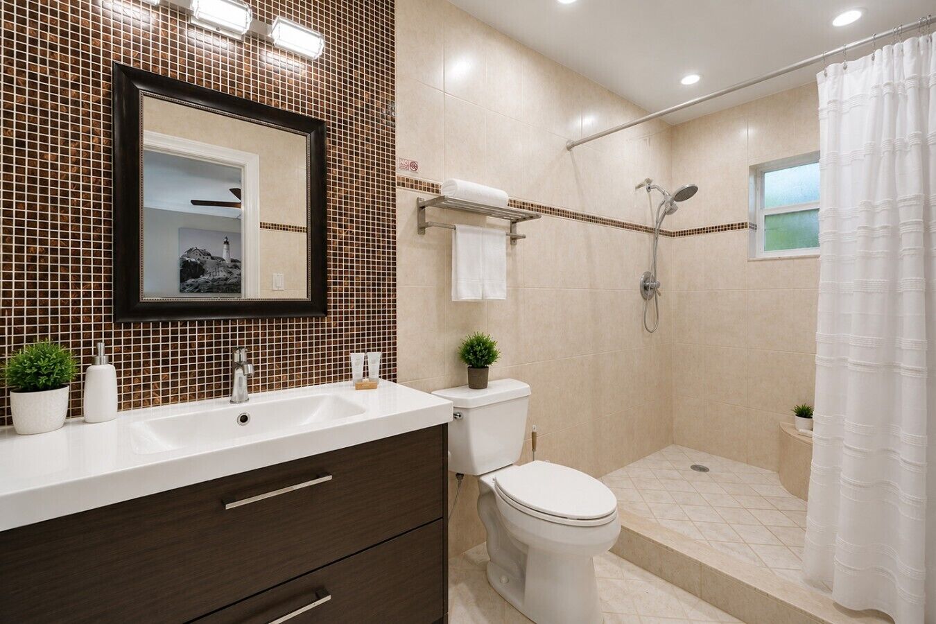 A modern bathroom with a shower, toilet, and sink.