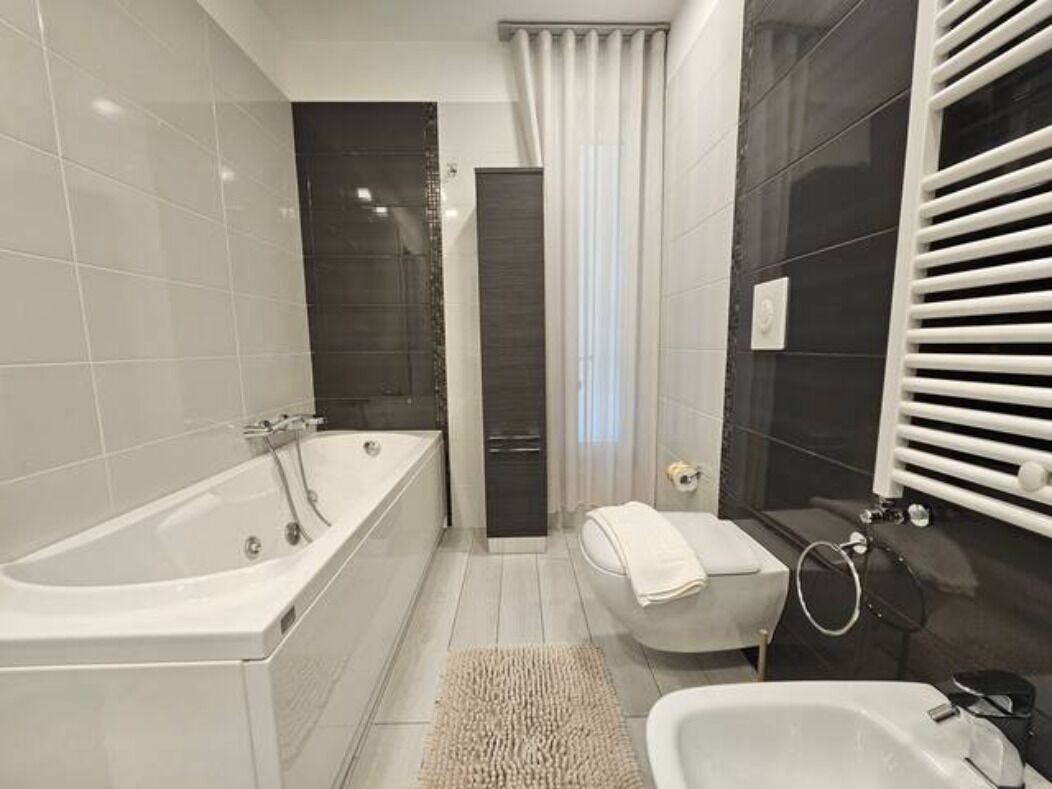 Un baño moderno con bañera, ducha y retrete.