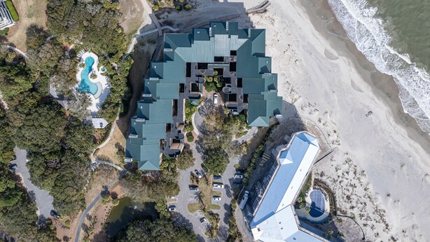 An aerial view of a resort with a large pool, multiple buildings, and a beach. - Oceanfront Ocean Club Villa in Wild Dunes w/Hot Tub & Community Pool! *Unit 1212* (Isle Of Palms)