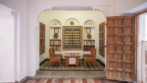 A library with bookshelves, a chessboard, and a wooden door. - KANKARWA HAVELI (Udaipur)