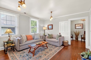 A living room with two sofas, a coffee table, a lamp, and a rug.