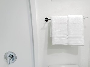 Een haardroger, handdoeken, zeep, shampoo