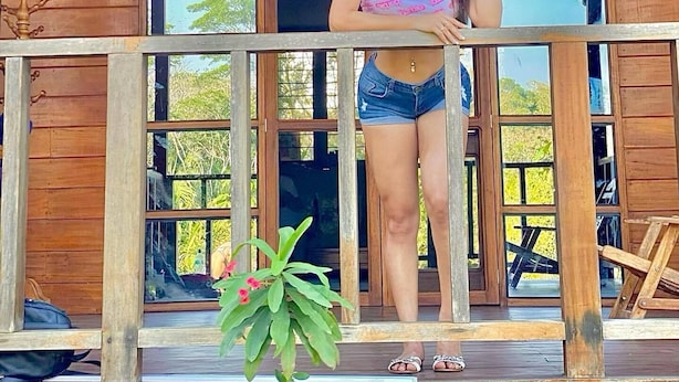 A wooden building with a sign reading "QUIRQUINCHO HOUSE TAMBOPATA". - Quirquincho House (Tambopata)