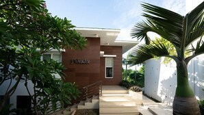 A modern building with a name sign 'Pihala' and a staircase leading to the entrance.