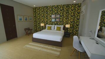 A bedroom with a bed, bedside tables, a desk, and a chair.