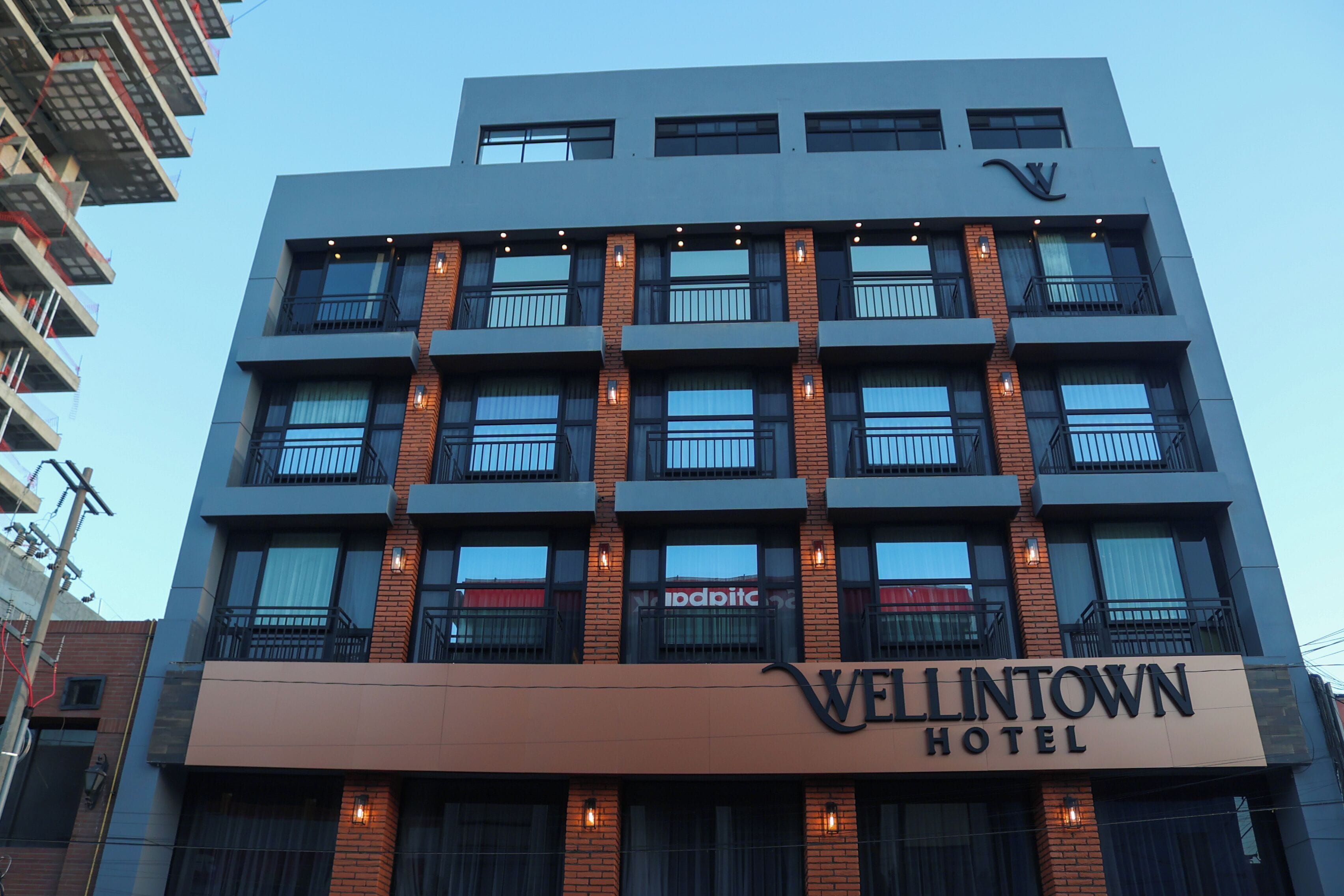 A modern hotel building with a sign reading "Vellintown Hotel".