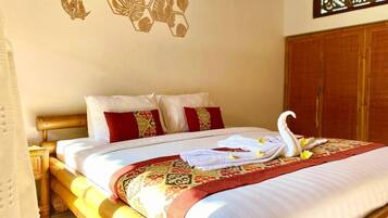 Relax in a traditional room with a large bed, patterned bedspread, and decorative wall hanging.