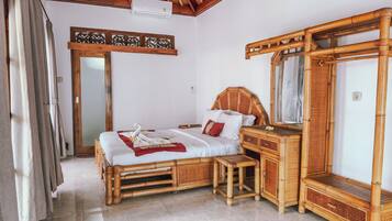A room with a bed, a wooden dresser, a mirror, and a ceiling fan.