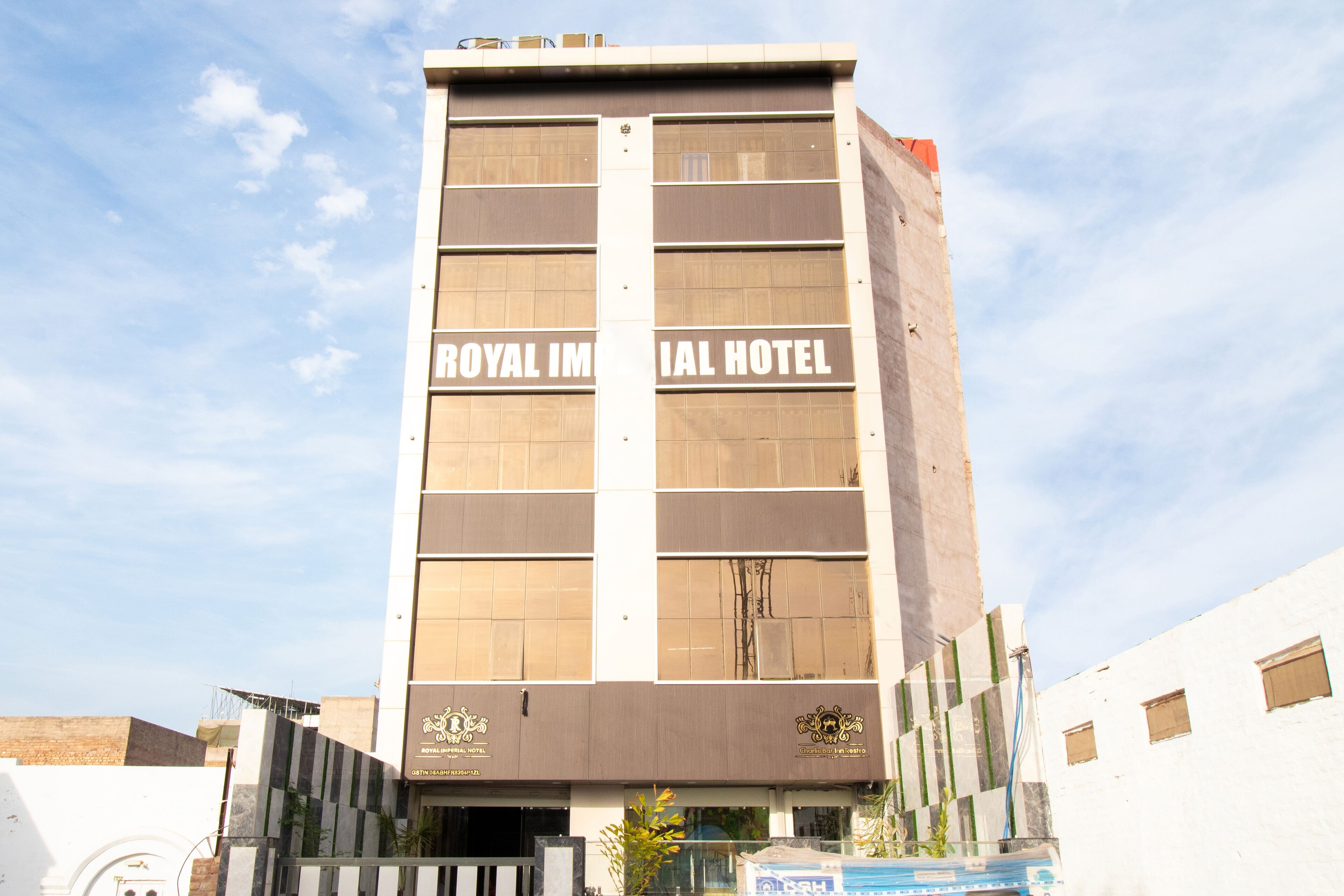 A tall hotel building with the name "ROYAL IMERAL HOTEL" prominently displayed on the facade.