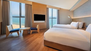 A hotel room with a large bed, a TV mounted on the wall, a small table, and a chair. - L7 HAEUNDAE by LOTTE HOTELS (Busan)
