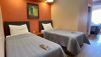 Family Triple Room, City View | Premium bedding, laptop workspace, blackout curtains, soundproofing