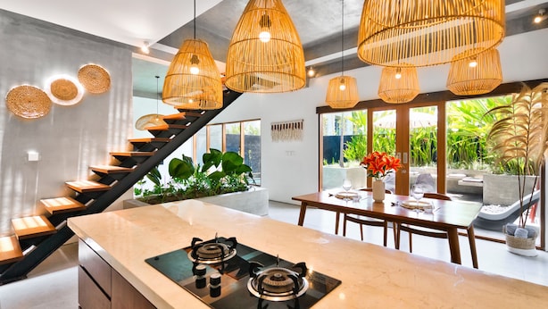 A modern kitchen with a central island, a staircase, and large windows. - Octo 6 Villa by Betterplace (Canggu)