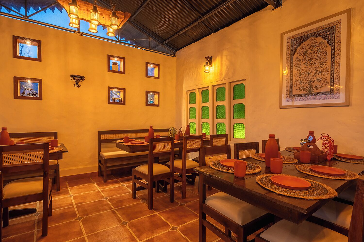 A dining area with a long table set for multiple people, surrounded by chairs.
