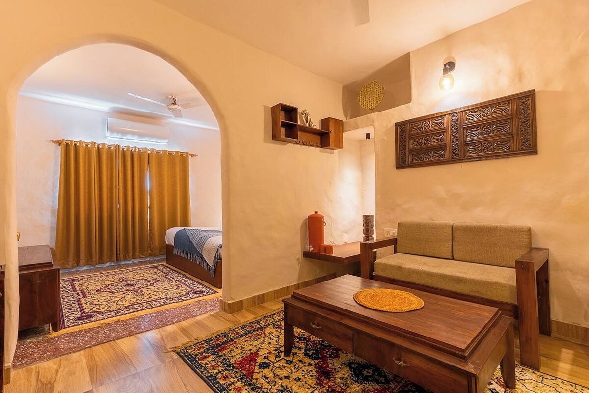 A cozy living room with a sofa, a coffee table, and a patterned rug.