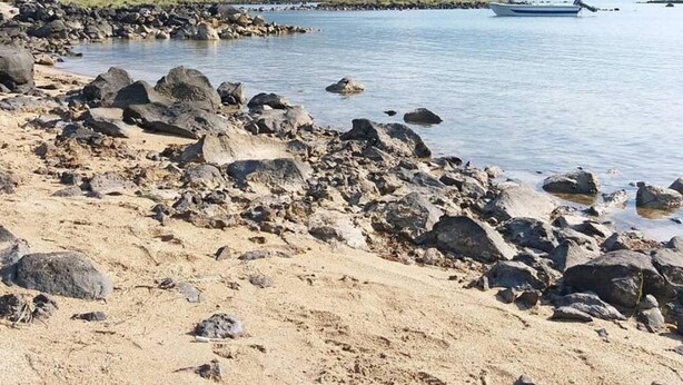 A rocky beach with a boat in the water and mountains in the background. - Daphnus Apartment in Agios Konstantinos (Kamena Vourla)