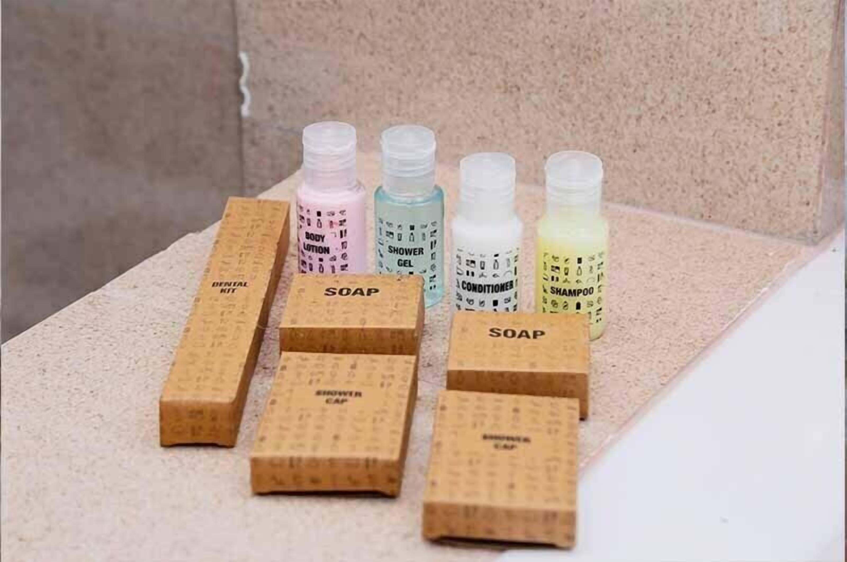 A set of toiletries arranged on a textured surface.