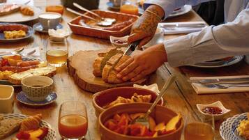 A breakfast table with various food items and utensils.