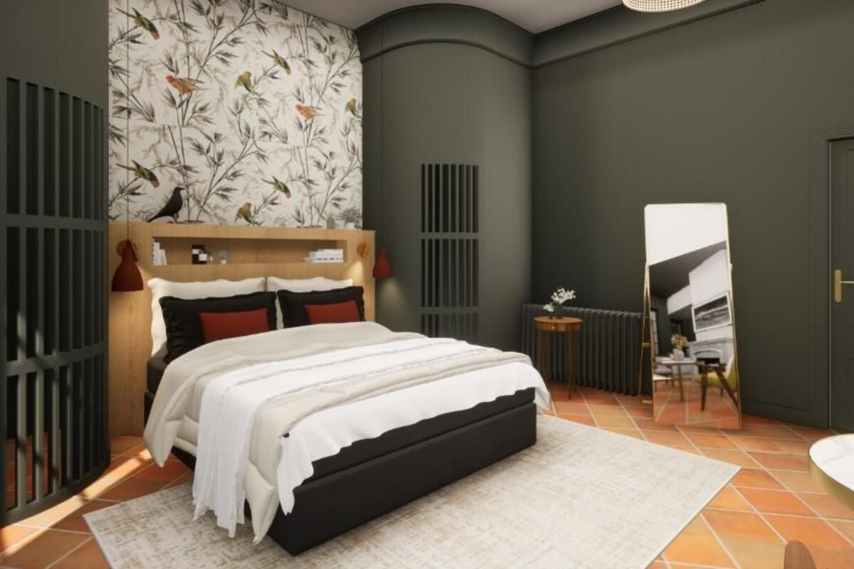 A bedroom with a bed, a mirror, a radiator, and a small table.