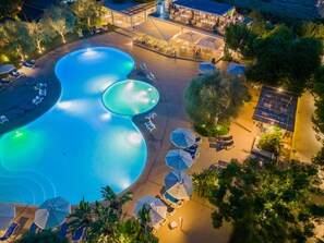 An aerial view of a resort with multiple swimming pools, sun loungers, and umbrellas. - Trezene Village (Castellabate)