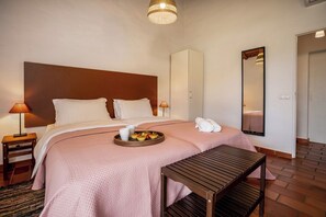 Relax in comfort with a large bed, nightstand, and wardrobe.