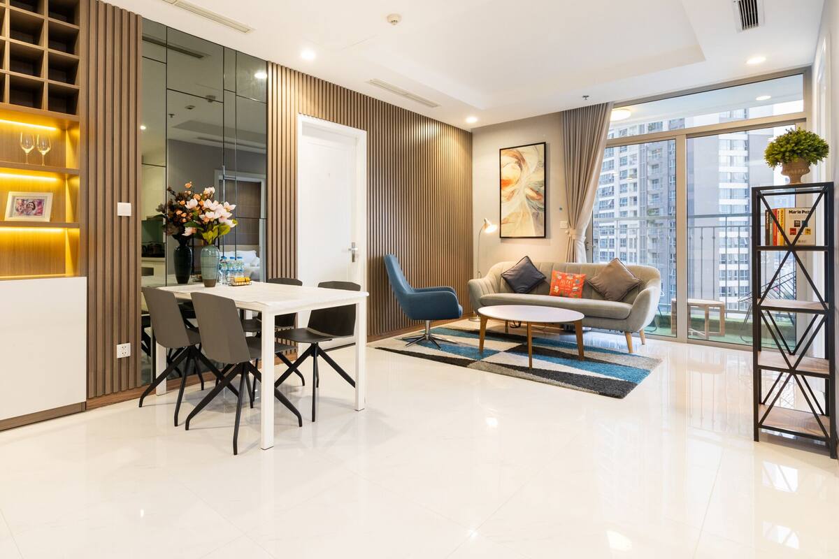 A modern living room with a dining area, a sofa, and a coffee table.