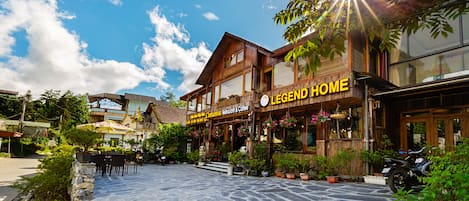 A building with a sign reading "LEGEND HOME" and "The Legend of the Mountain Restaurant & Coffee."