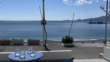 Relax in a serene outdoor space with a stunning sea view, perfect for dining or unwinding.