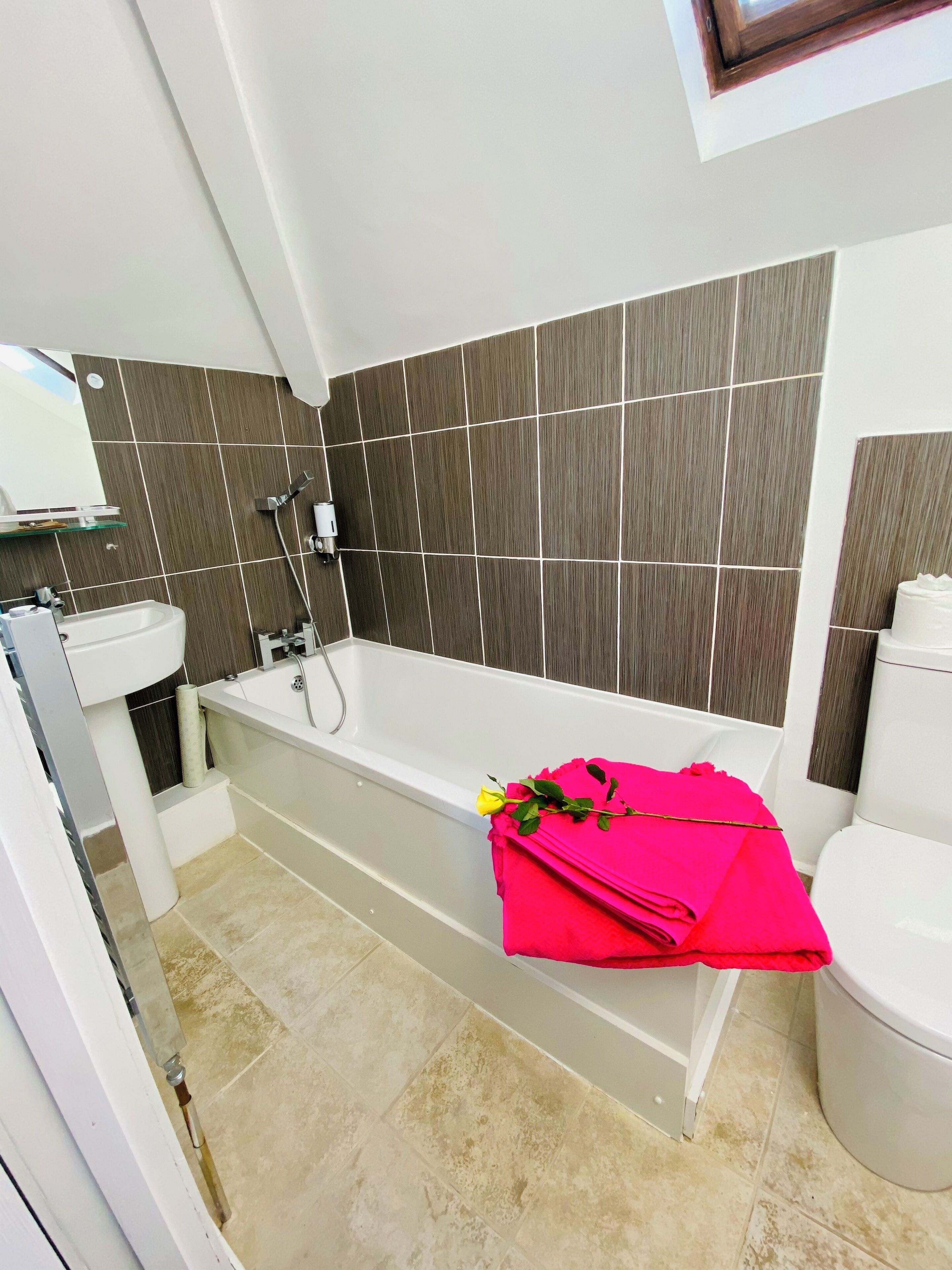 Ein modernes Badezimmer mit einer Badewanne, einem Waschbecken und einer Toilette.