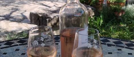 Two wine glasses and a bottle on a table with a tiled pattern.