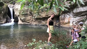 A natural setting with a waterfall, clear water, and rocky terrain. - The Backyard Blangoda (Balangoda)