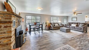 A spacious living room with a fireplace, a dining area, and a sofa set. - New Blaine Getaway - Walk to Lake Dardanelle! (New Blaine)