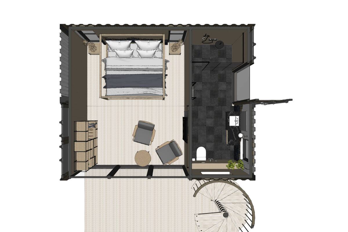 Blick von oben auf ein kleines Hotelzimmer mit Bett, einer Sitzecke, einem Badezimmer und einer Wendeltreppe.