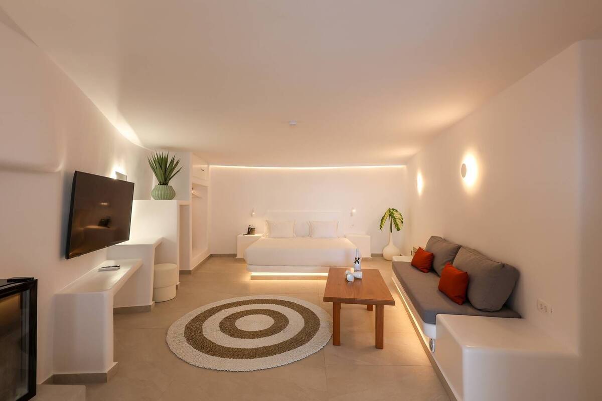 A modern living room with a sofa, coffee table, and TV.