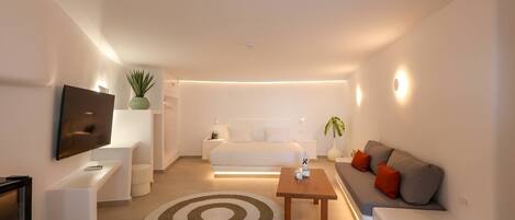 A modern living room with a sofa, coffee table, and TV.
