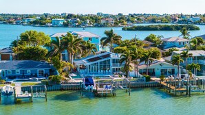 A waterfront property with multiple houses, a dock, and a clear view of the water.