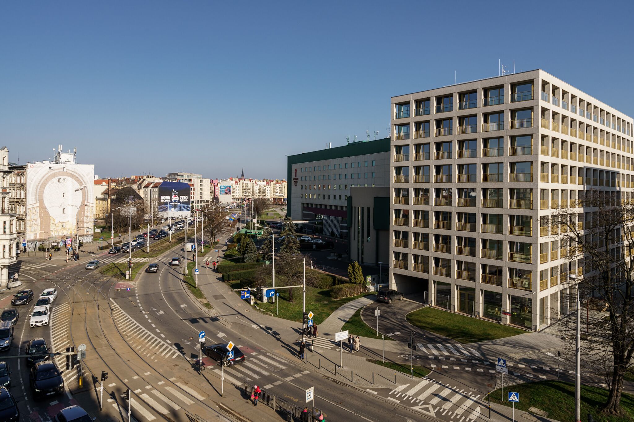 A modern building with a grid-like facade and multiple balconies.